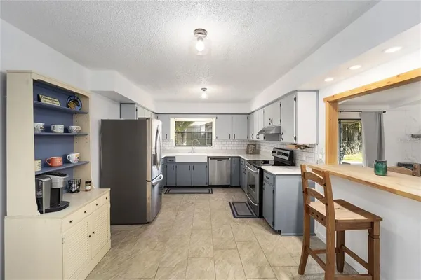 a kitchen with refrigerator a sink and cabinets