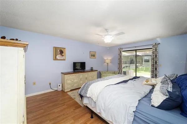 a bedroom with a large bed and a tv