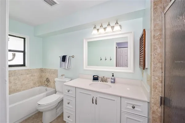 a bathroom with a sink toilet tub and vanity