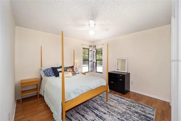 a bedroom with a bed and wooden floor