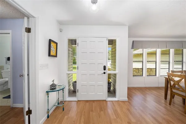 a view of a livingroom with wooden floor and furniture