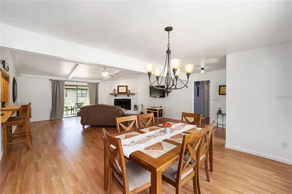 a view of a dining room with furniture wooden floor and chandelier