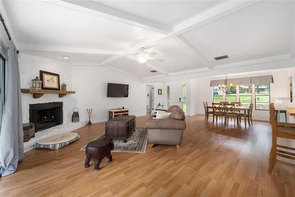 a living room with fireplace furniture and a flat screen tv