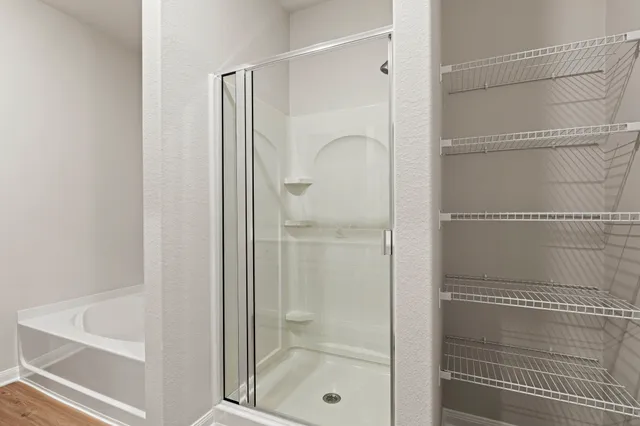 a bathroom with a glass shower door