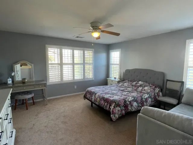 a bedroom with a bed couch and window