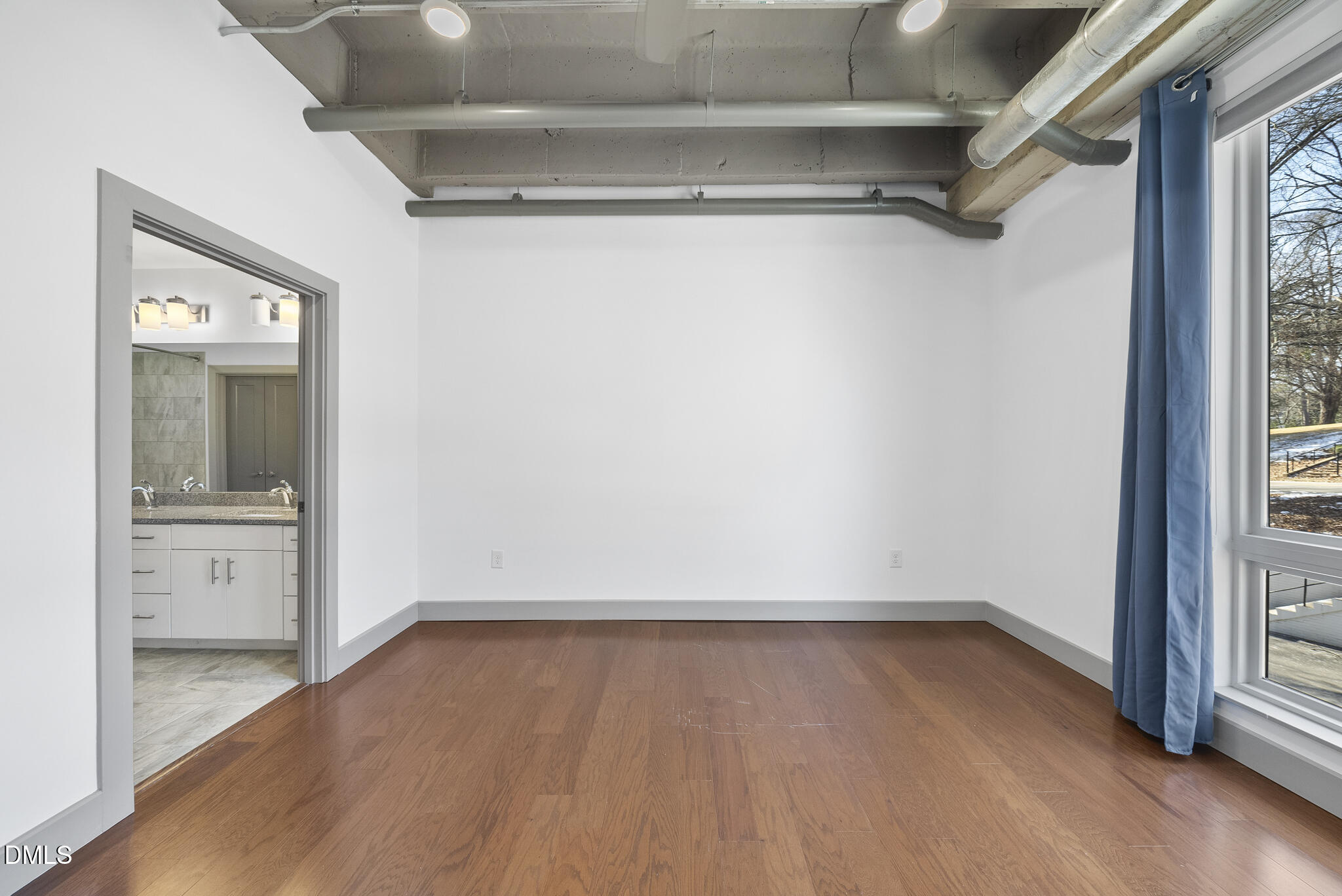 1300 St Marys Street, Unit 207 Raleigh, NC 27605 - Photo 14 of 18 a view of a room with wooden floor and a window