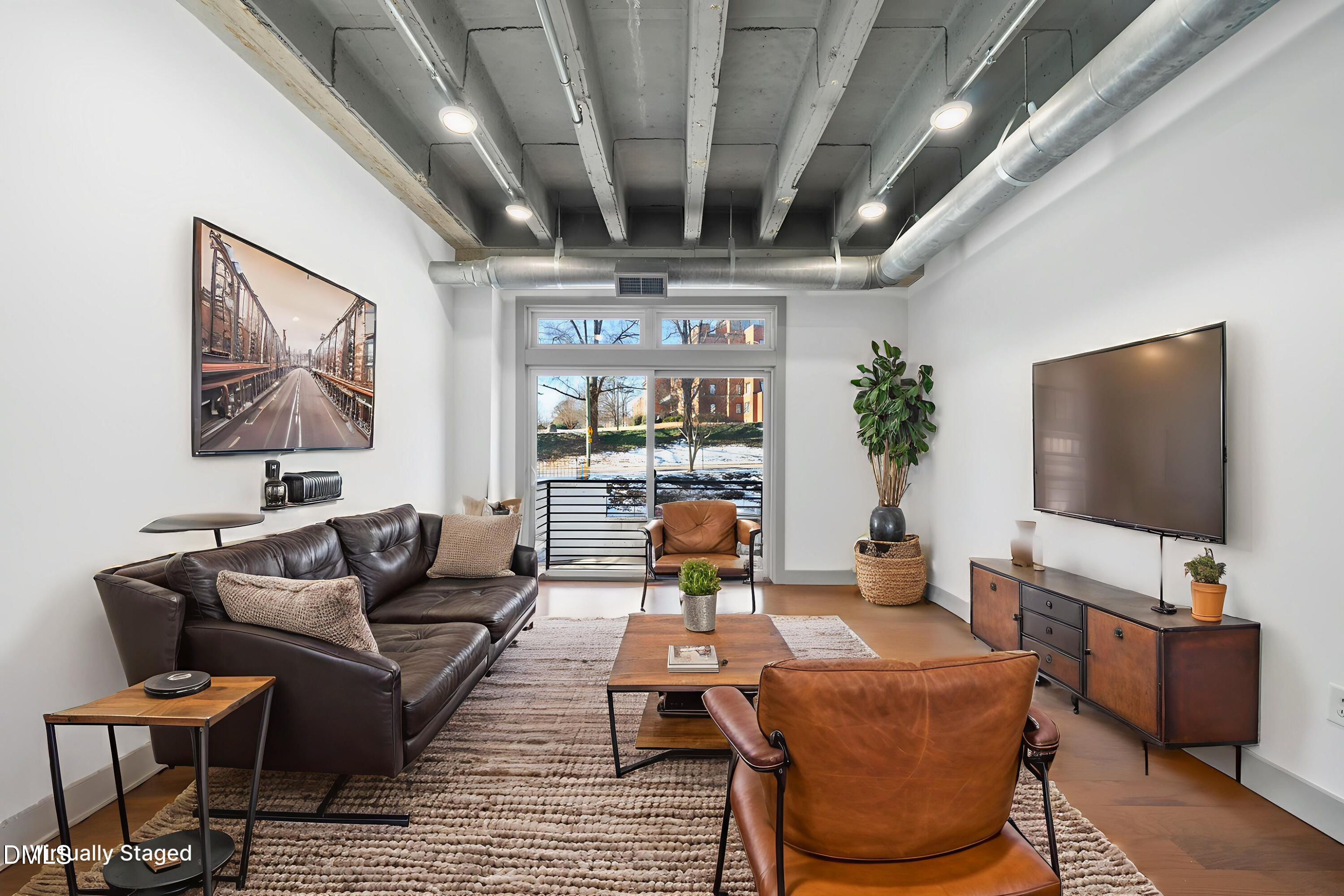 1300 St Marys Street, Unit 207 Raleigh, NC 27605 - Photo 2 of 18 a living room with furniture and a flat screen tv