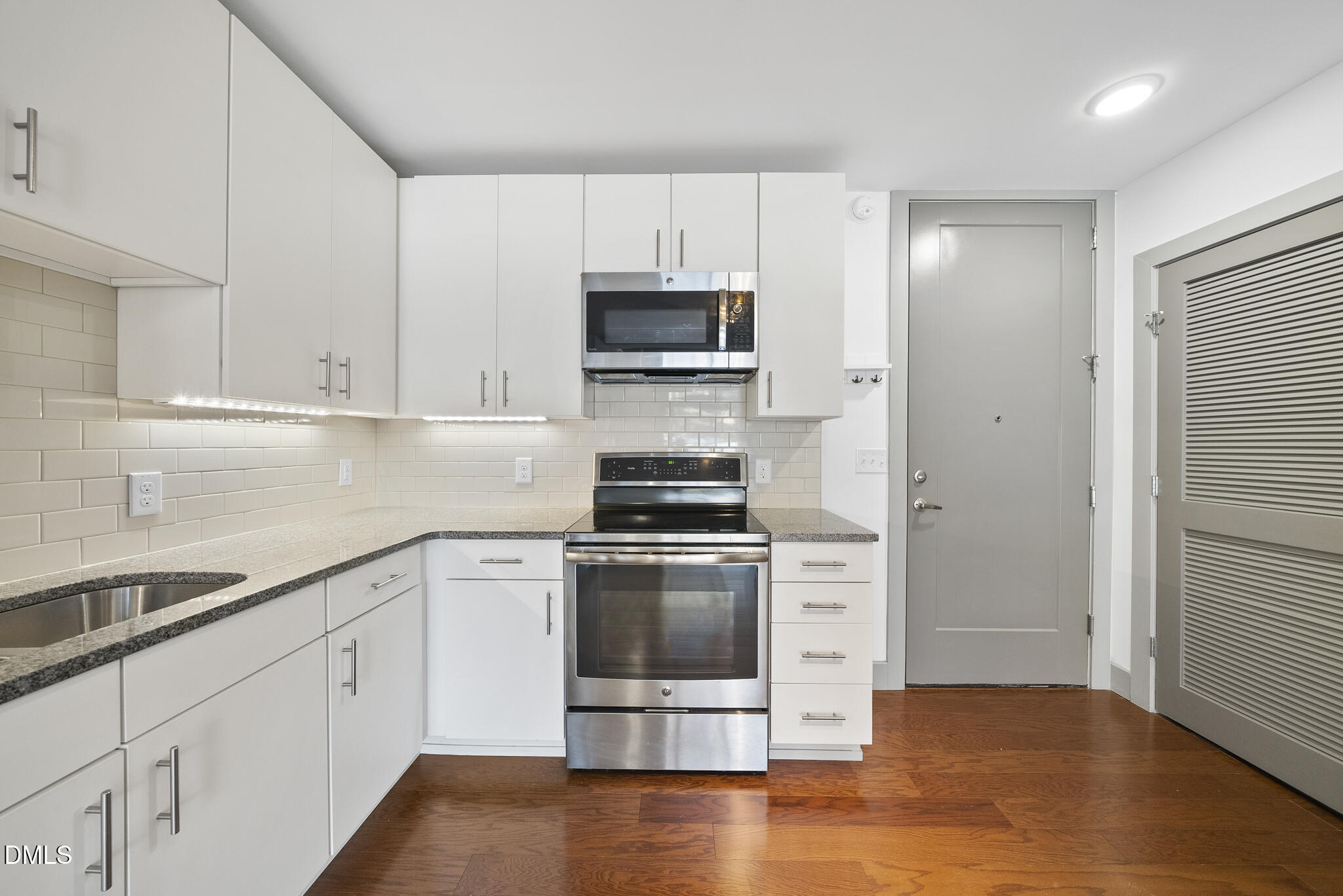 1300 St Marys Street, Unit 207 Raleigh, NC 27605 - Photo 5 of 18 a kitchen with a stove and a sink