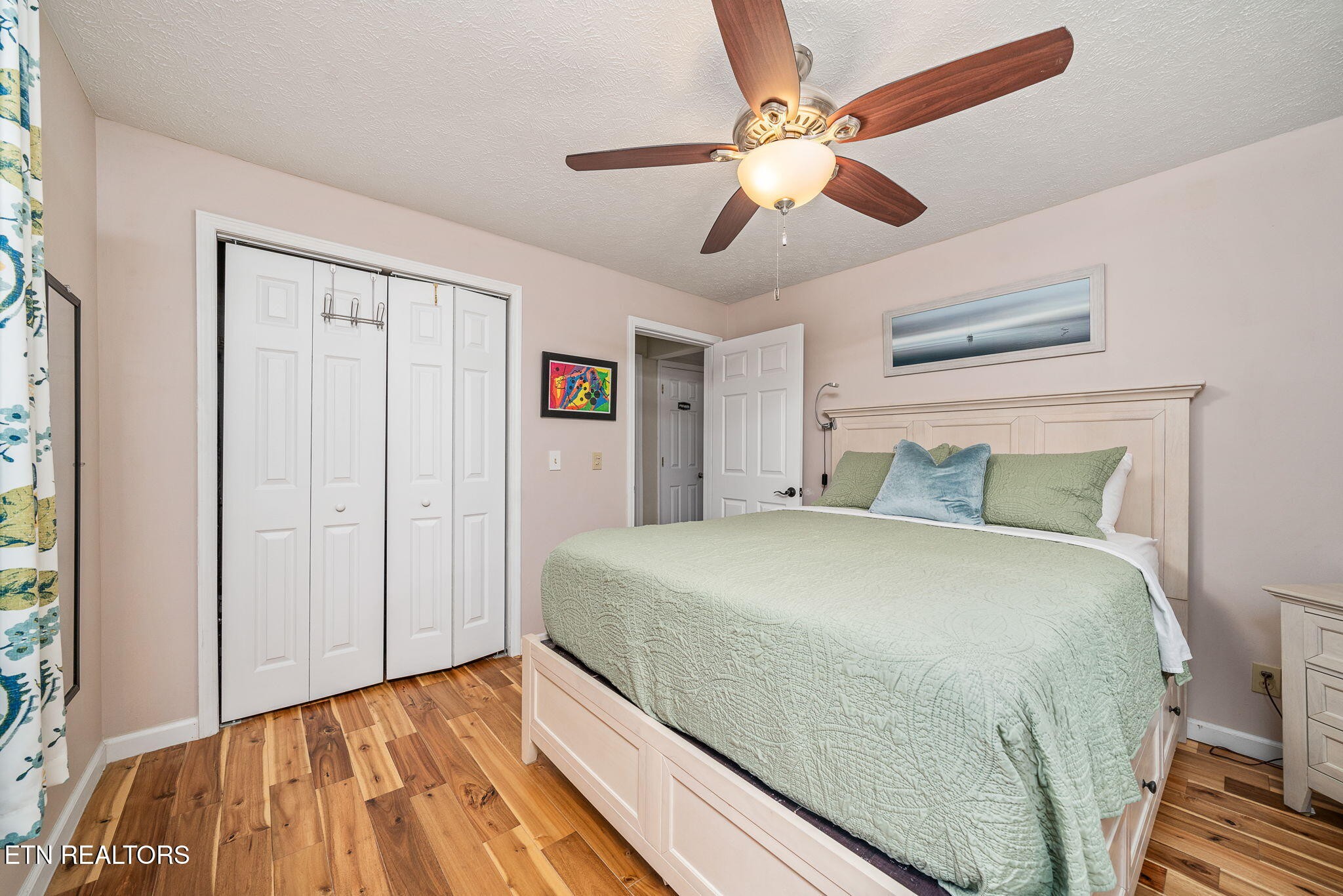 279 Siever Road Crossville, TN 38572 - Photo 15 of 35 a spacious bedroom with a bed and a chandelier