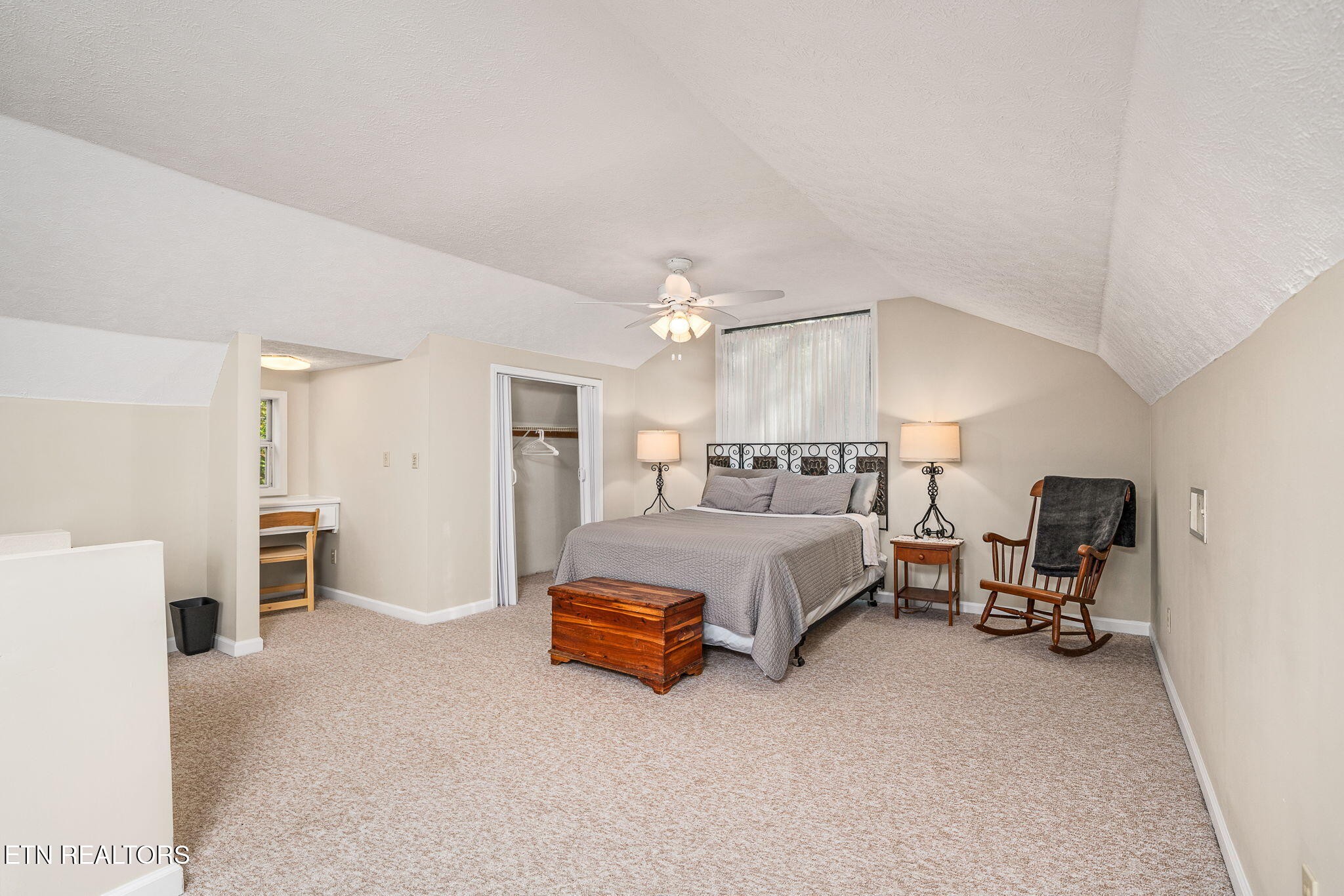 279 Siever Road Crossville, TN 38572 - Photo 18 of 35 a spacious bedroom with a bed and a chandelier