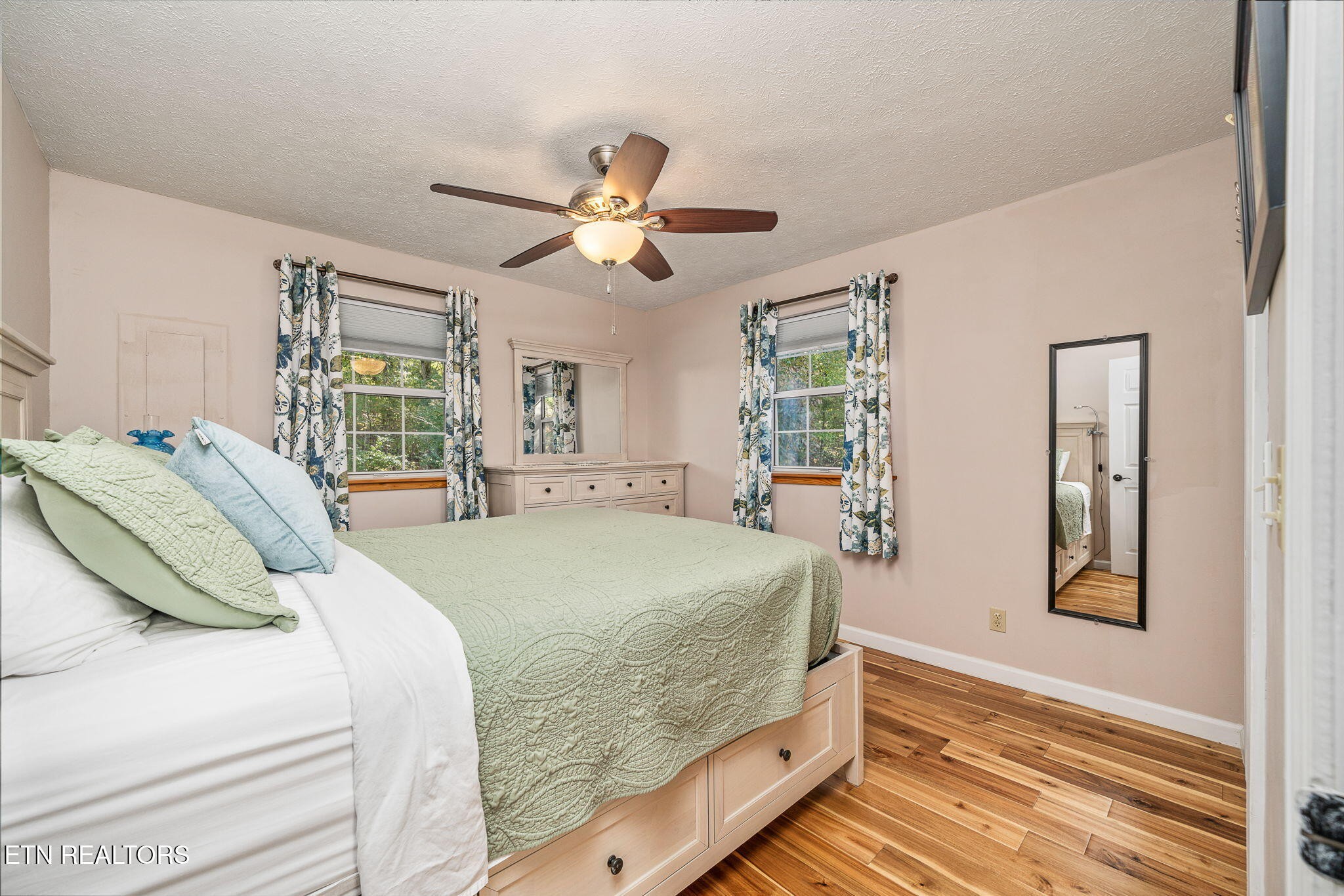 279 Siever Road Crossville, TN 38572 - Photo 6 of 35 a bedroom with a large bed and a chandelier