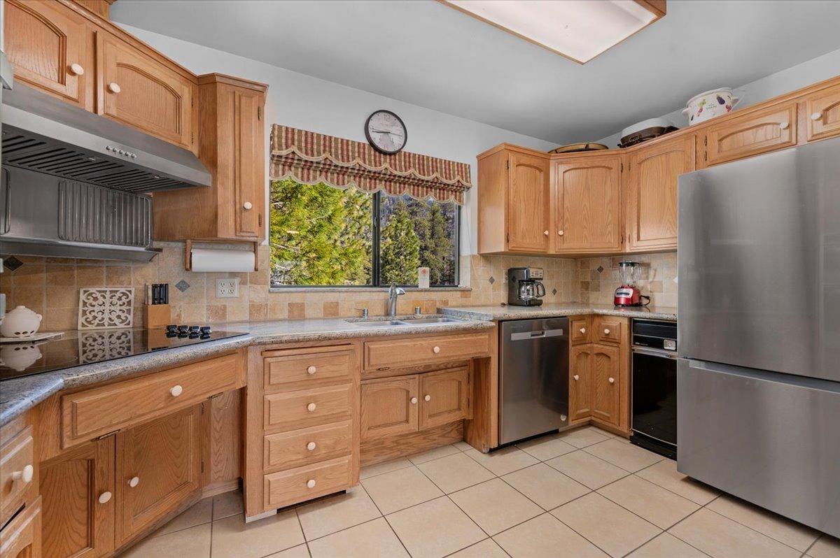 63221 Huntington Vista Road, Unit 83 Mono Hot Springs, CA 93642 - Photo 7 of 42 a kitchen with stainless steel appliances granite countertop a refrigerator sink and cabinets