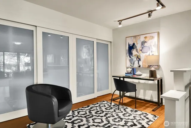 a view of a workspace with furniture and a window