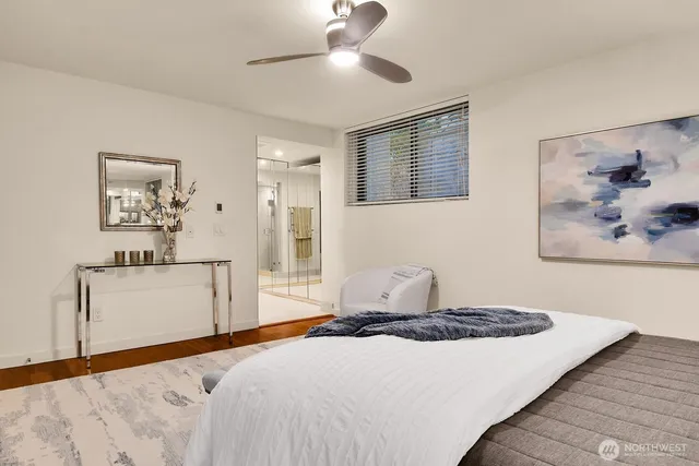 a bedroom with a large bed and a chandelier