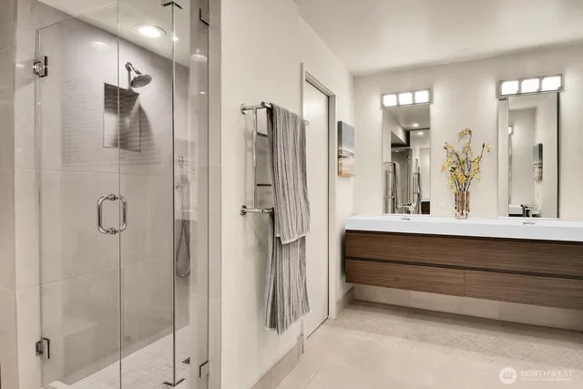 a bathroom with a double vanity sink shower and a mirror