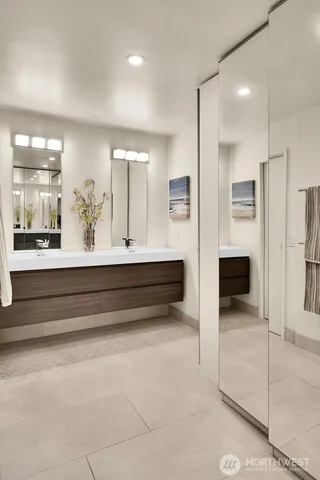 a bathroom with a double vanity sink and a mirror
