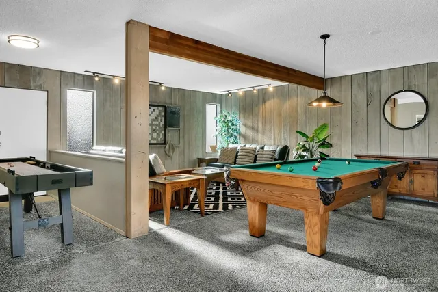 a room with stainless steel appliances kitchen island granite countertop furniture and a table