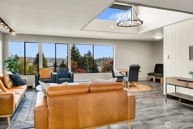 a living room with furniture and floor to ceiling window