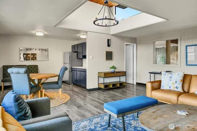 a living room with furniture a couch and a chandelier
