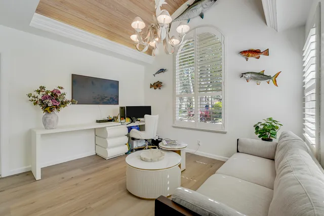 a living room with furniture and a chandelier