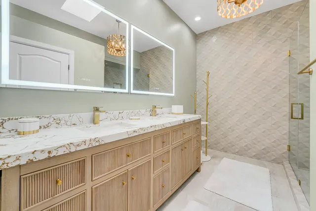 a bathroom with a granite countertop sink mirror and double