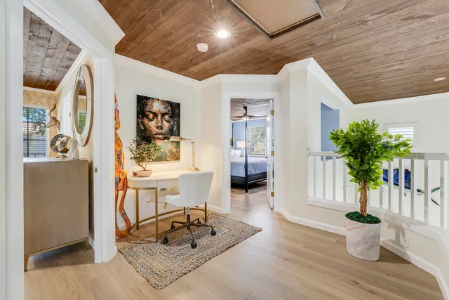 a living room with furniture and a potted plant