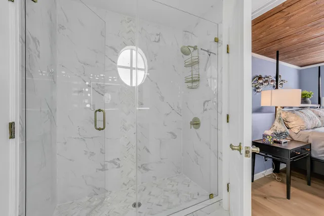 a bathroom with a granite countertop shower a mirror and a sink
