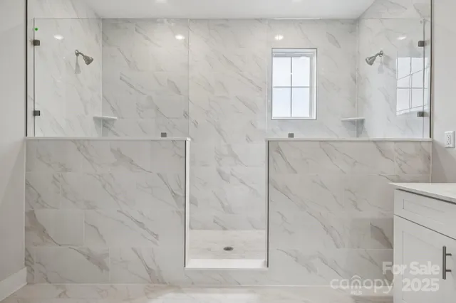 a view of an empty room with a fireplace and a window