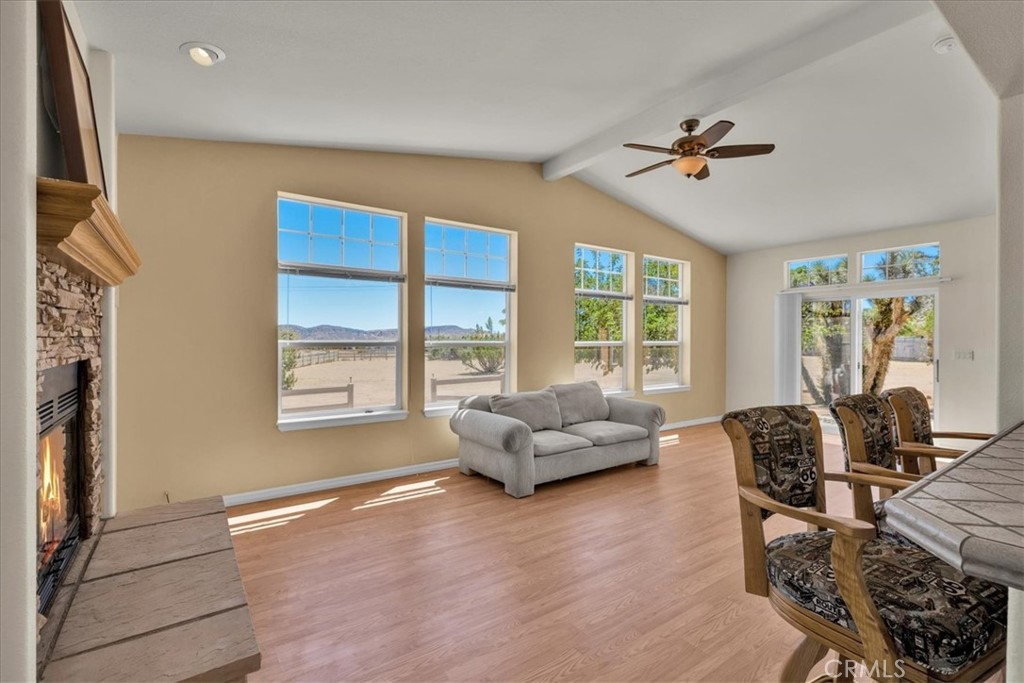 5175 Tom Mix Road Pioneertown, CA 92268 - Photo 17 of 58 a living room with furniture floor to ceiling window and a flat screen tv