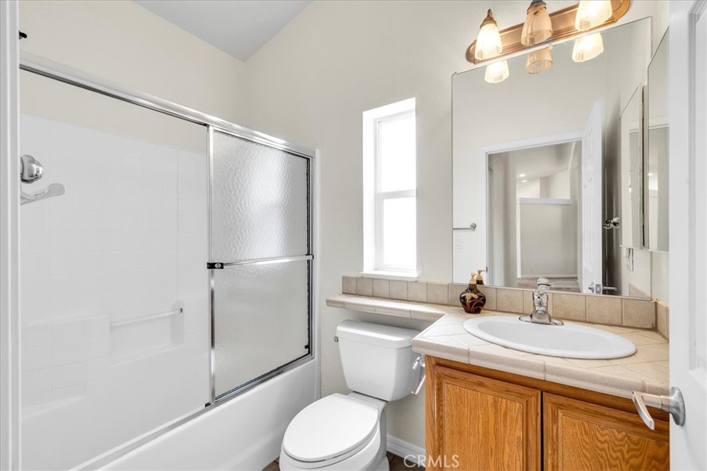 5175 Tom Mix Road Pioneertown, CA 92268 - Photo 30 of 58 a bathroom with a granite countertop sink toilet and shower