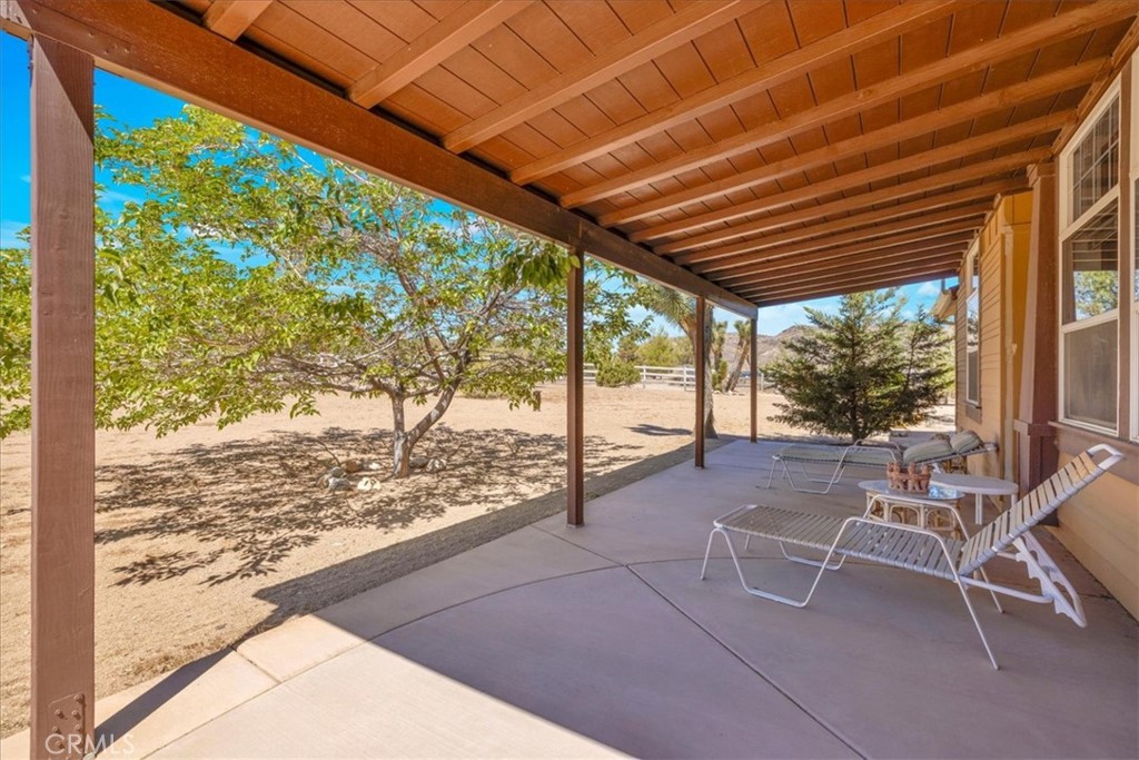 5175 Tom Mix Road Pioneertown, CA 92268 - Photo 8 of 58 a view of a porch with chairs and backyard