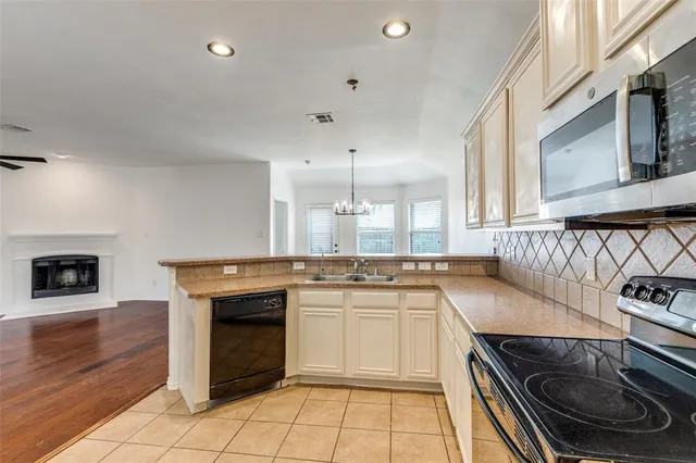 a kitchen with stainless steel appliances granite countertop a stove and a sink