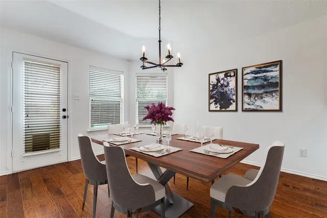 a view of a dining room with furniture wooden floor and chandelier