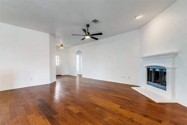 wooden floor in an empty room with a fireplace