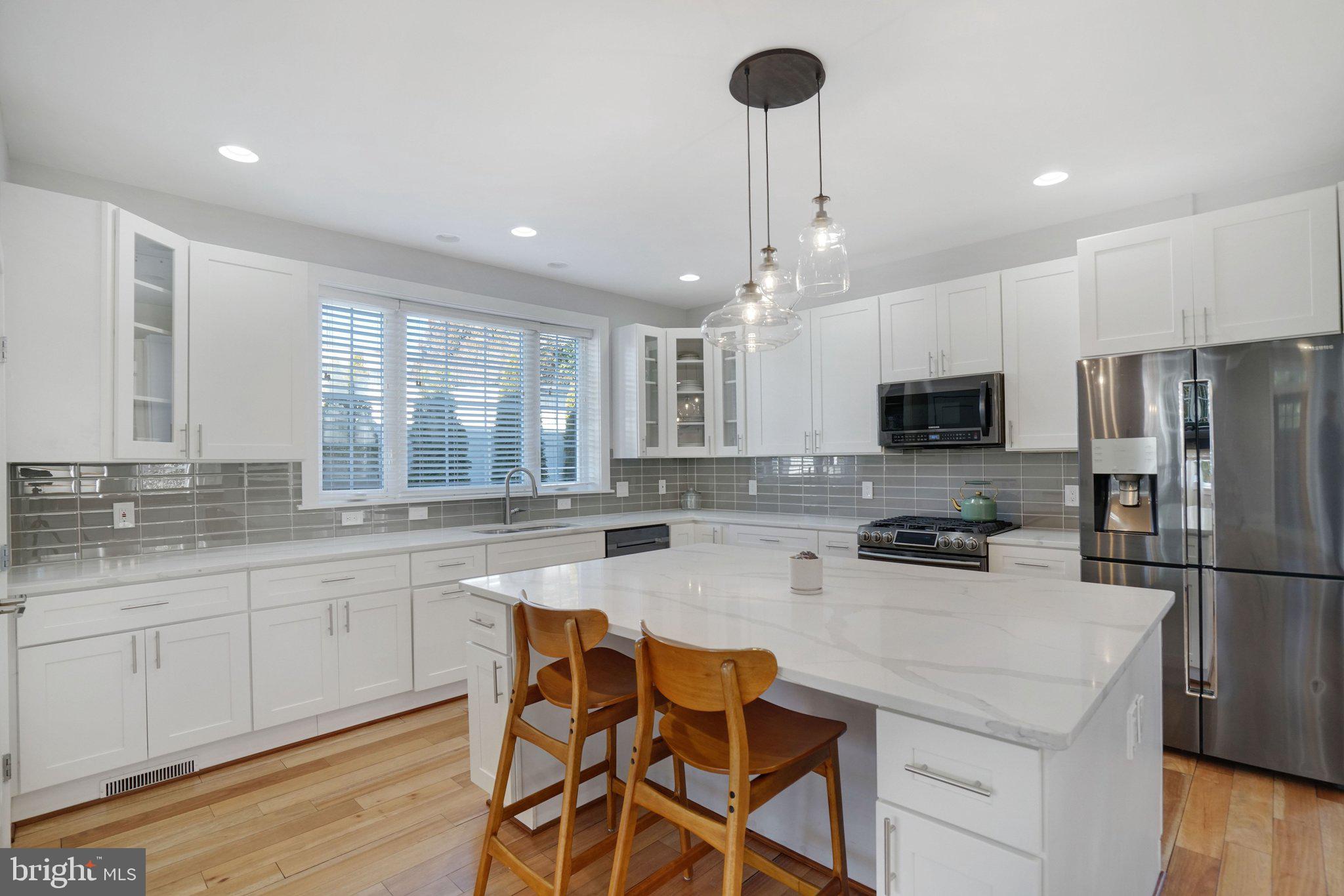 3731 Duke Street Alexandria, VA 22304 - Photo 11 of 57 a kitchen with stainless steel appliances a stove a sink a refrigerator and cabinets