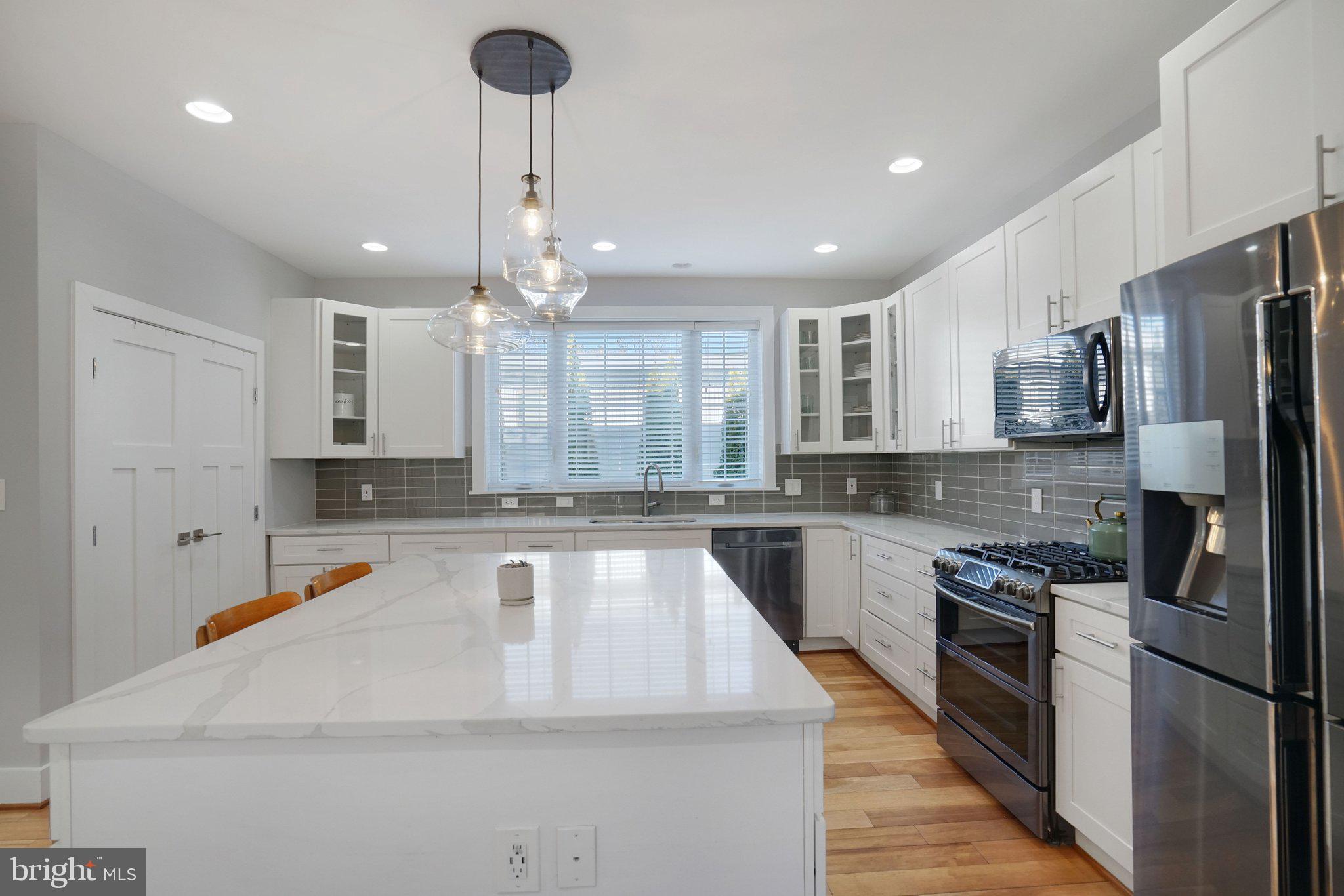 3731 Duke Street Alexandria, VA 22304 - Photo 13 of 57 a large kitchen with a large center island stainless steel appliances and cabinets