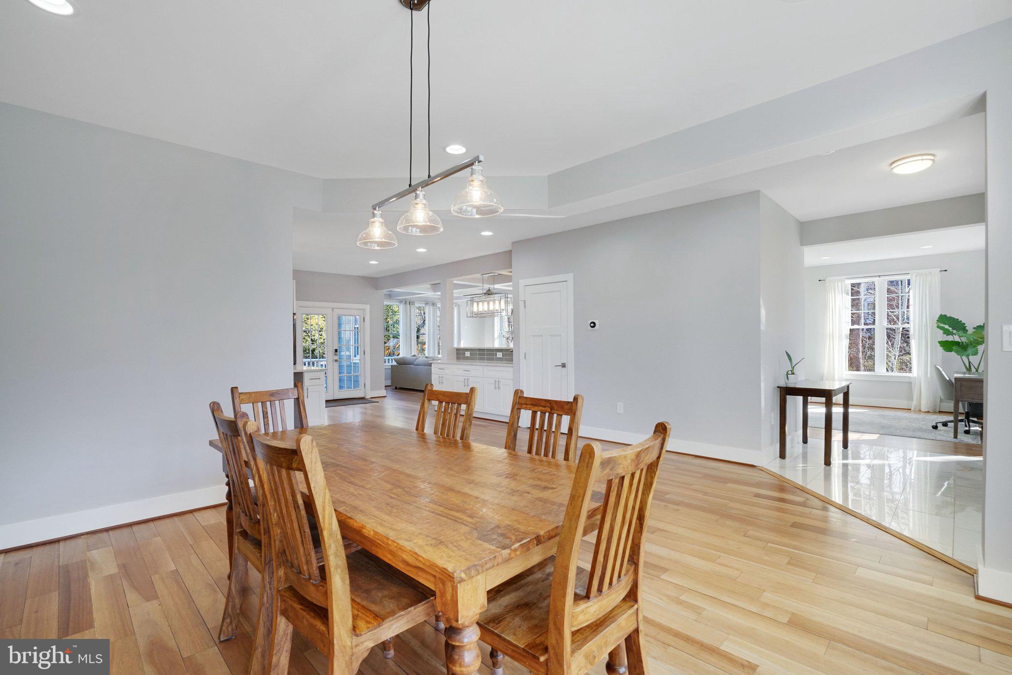 3731 Duke Street Alexandria, VA 22304 - Photo 16 of 57 a view of a dining room and livingroom with furniture wooden floor a chandelier