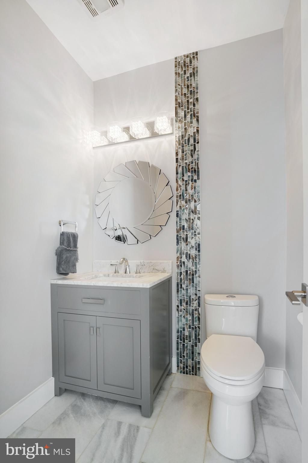 3731 Duke Street Alexandria, VA 22304 - Photo 22 of 57 a bathroom with a sink a toilet and mirror