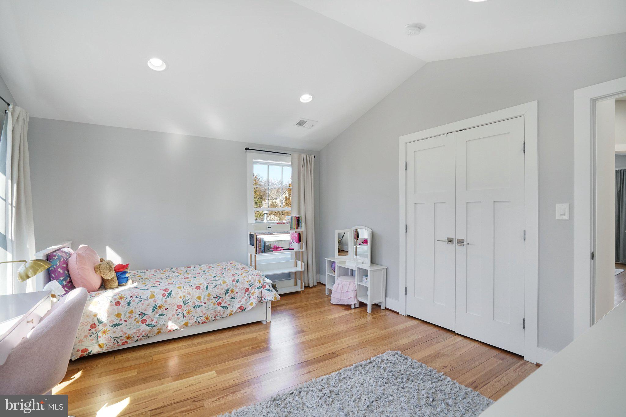 3731 Duke Street Alexandria, VA 22304 - Photo 32 of 57 a bedroom with a bed and wooden floor