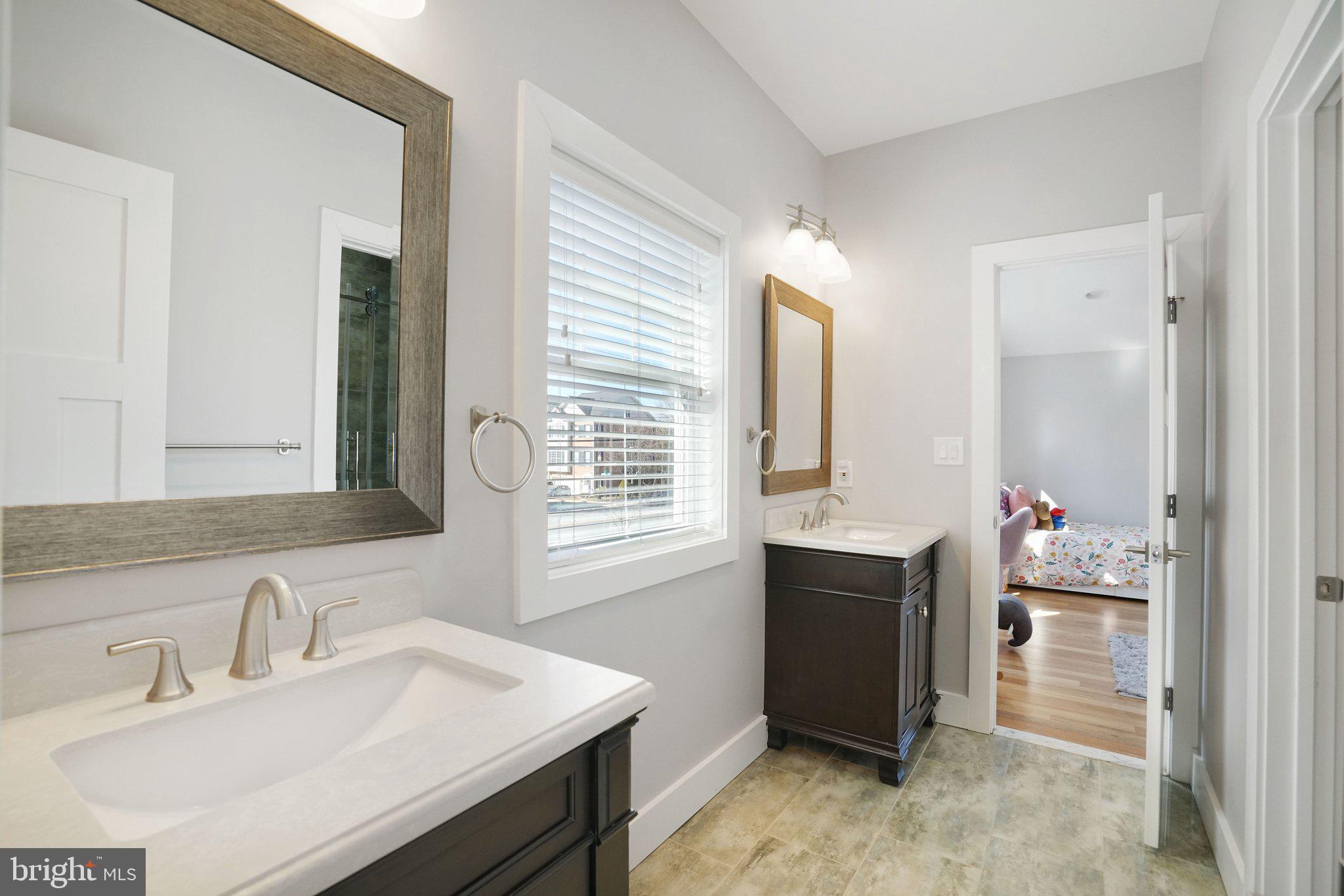 3731 Duke Street Alexandria, VA 22304 - Photo 34 of 57 a bathroom with a sink vanity tub and a mirror