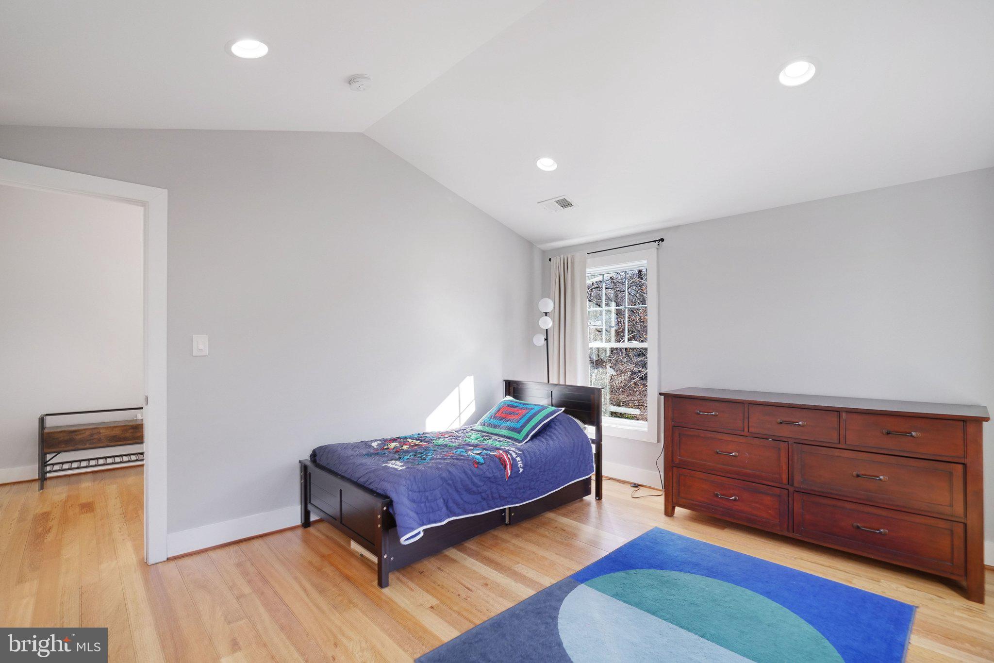 3731 Duke Street Alexandria, VA 22304 - Photo 36 of 57 a bedroom with a bed and wooden floor