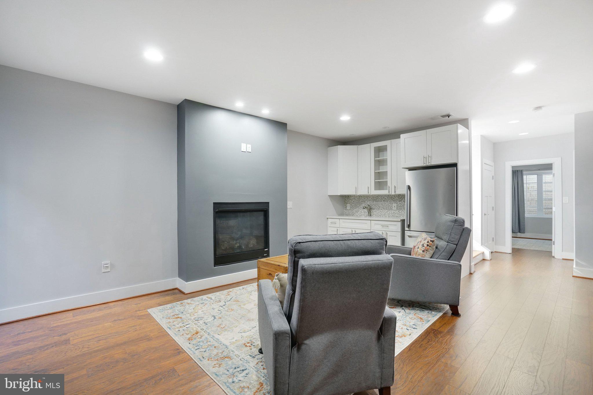 3731 Duke Street Alexandria, VA 22304 - Photo 37 of 57 a living room with stainless steel appliances furniture a rug and a kitchen view
