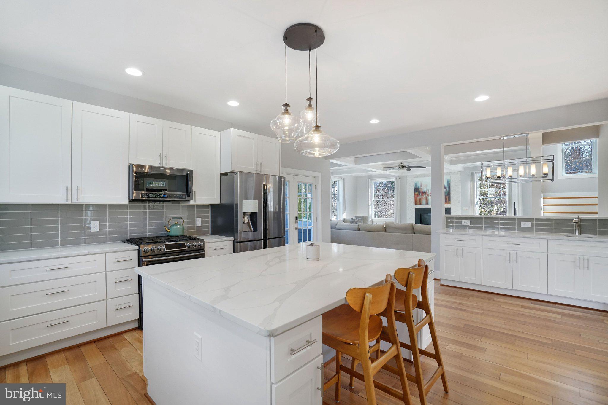 3731 Duke Street Alexandria, VA 22304 - Photo 10 of 57 a large kitchen with kitchen island a large island in the center and stainless steel appliances
