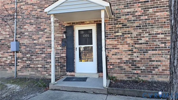 a brick building with a window and a door