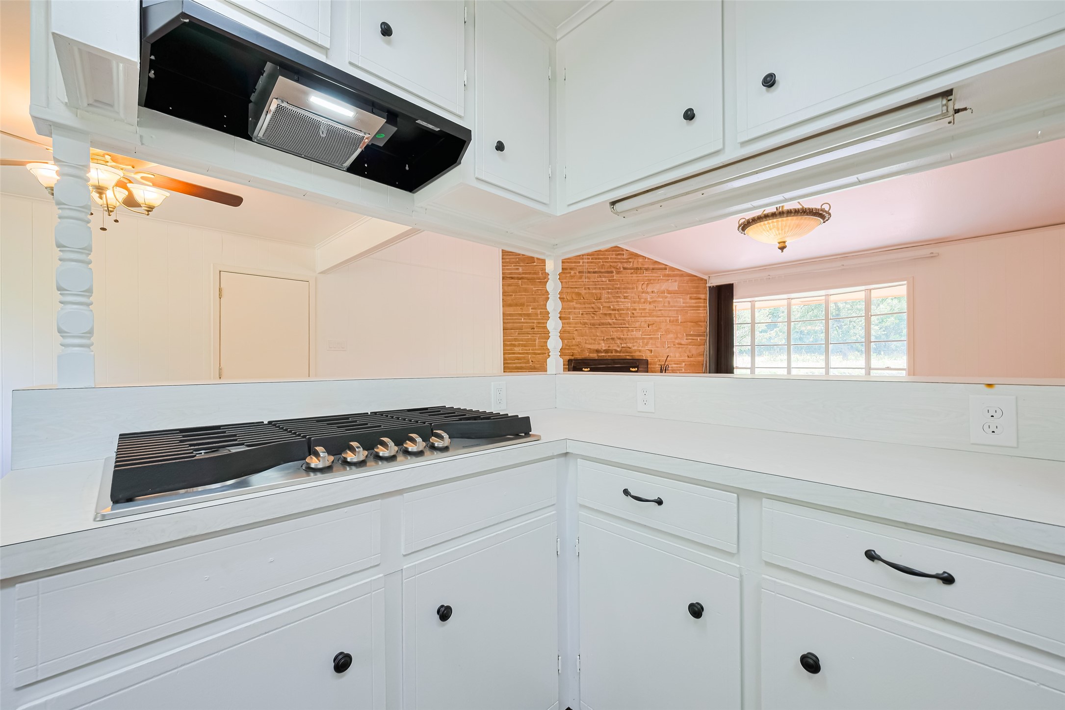30525 Hegar Road Hockley, TX 77447 - Photo 13 of 49 a kitchen with white cabinets and black appliances