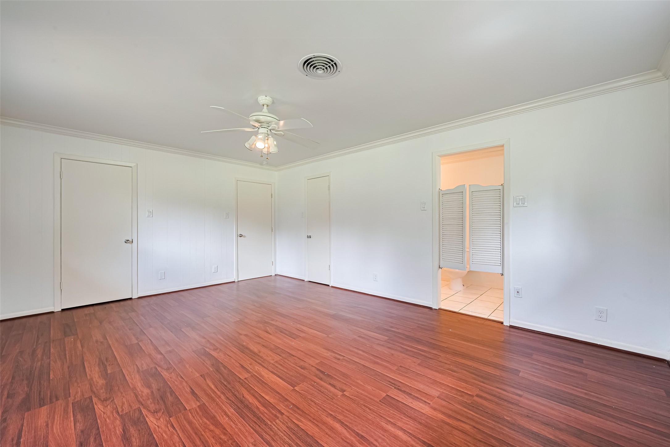 30525 Hegar Road Hockley, TX 77447 - Photo 28 of 49 a view of an empty room with wooden floor and a ceiling fan