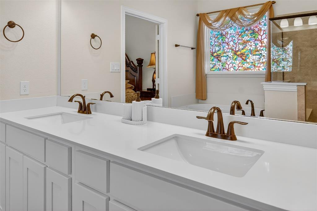 157 Misty Mountain Lane Rhome, TX 76078 - Photo 17 of 40 Primary bathroom with double vanity, ensuite bathroom, and a tile shower