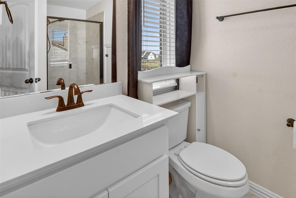 157 Misty Mountain Lane Rhome, TX 76078 - Photo 27 of 40 Second floor Bathroom with a textured wall, vanity, healthy amount of natural light, and a shower stall