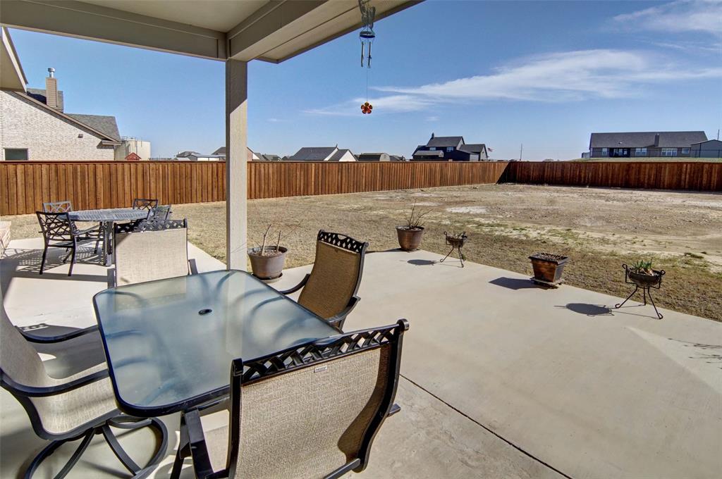 157 Misty Mountain Lane Rhome, TX 76078 - Photo 30 of 40 Fenced backyard with outdoor dining space, a patio