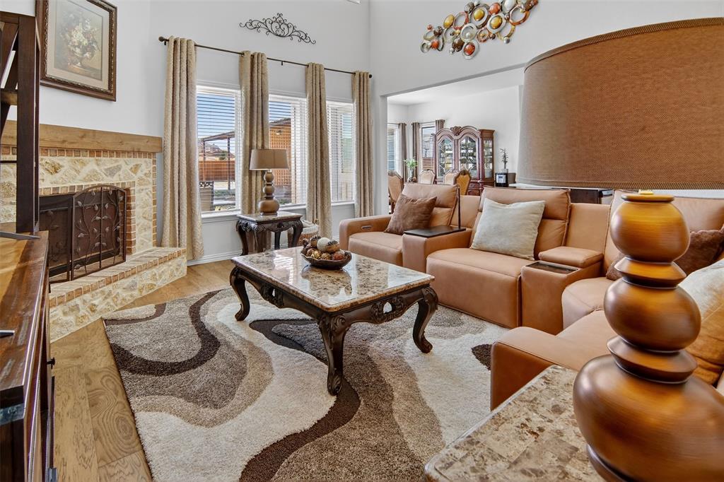 157 Misty Mountain Lane Rhome, TX 76078 - Photo 8 of 40 Living area featuring a fireplace, wood finished floors, and a high ceiling